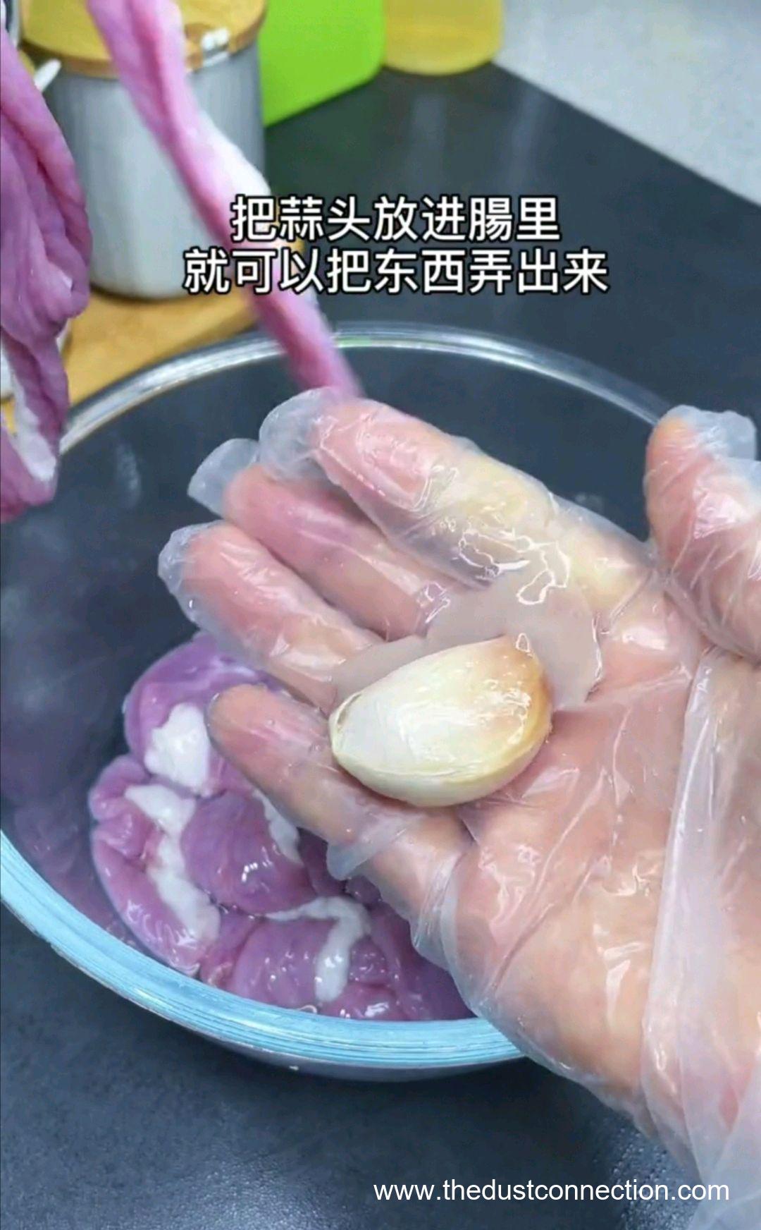 one clove of garlic in hand